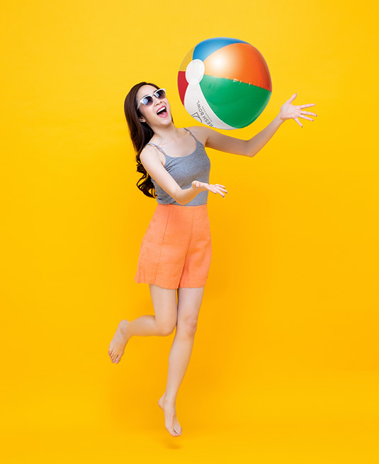 Happy person playing with a custom beachball.