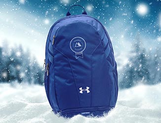 Backpack with custom logo in front of a snowy background.