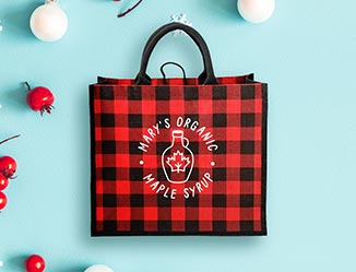 Buffalo plaid tote bag with custom imprint on a holiday decorated table.