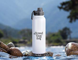 Large water bottle with logo sitting on a rock in a stream.