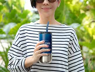 Person holding customized tumbler with straw