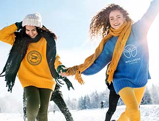 Happy people wearing logoed apparel in the snow